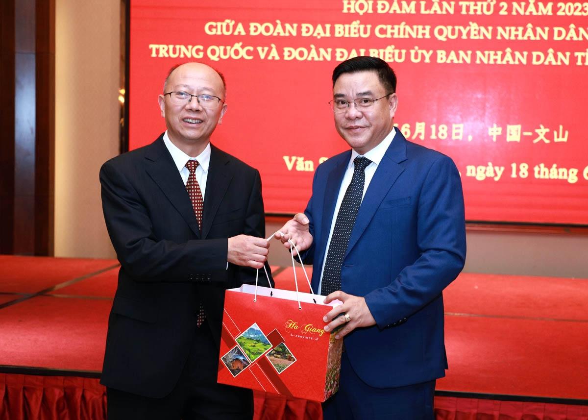 Phó Chủ tịch Thường trực UBND tỉnh Hoàng Gia Long tặng quà đồng chí Lục Ba, Phó Châu trưởng chính quyền nhân dân châu Văn Sơn.